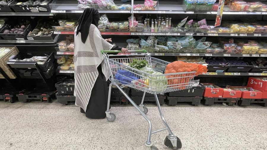 CARDIFF, WALES - OCTOBER 19: A woman shops in a greengrocers in Cardiff Market on October 19, 2022 in Cardiff, United Kingdom. The Office for National Statistics (ONS) said the consumer prices index (CPI) measure rose from an annual rate of 9.9% in August to match the recent 40-year high of 10.1% seen in July. The largest contributing factor being the rise in food costs. (Photo by Matthew Horwood/Getty Images)