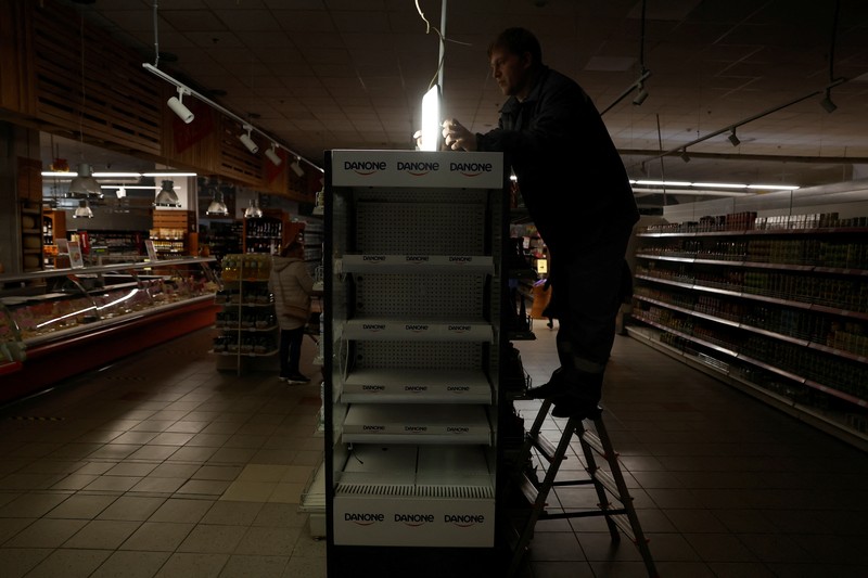 People shop in a supermarket as Kharkiv suffers an electricity outage, amid Russia's attack on Ukraine, in Kharkiv, Ukraine, October 17, 2022. REUTERS/Clodagh Kilcoyne