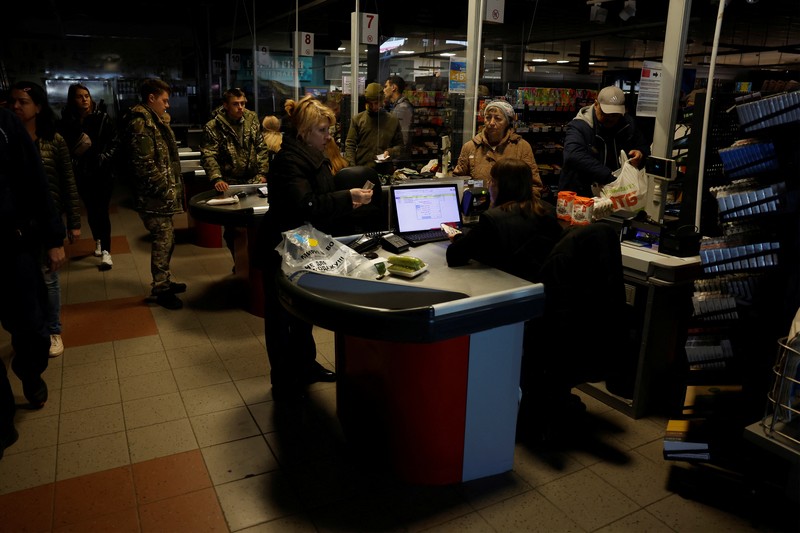 People shop in a supermarket as Kharkiv suffers an electricity outage, amid Russia's attack on Ukraine, in Kharkiv, Ukraine, October 17, 2022. REUTERS/Clodagh Kilcoyne