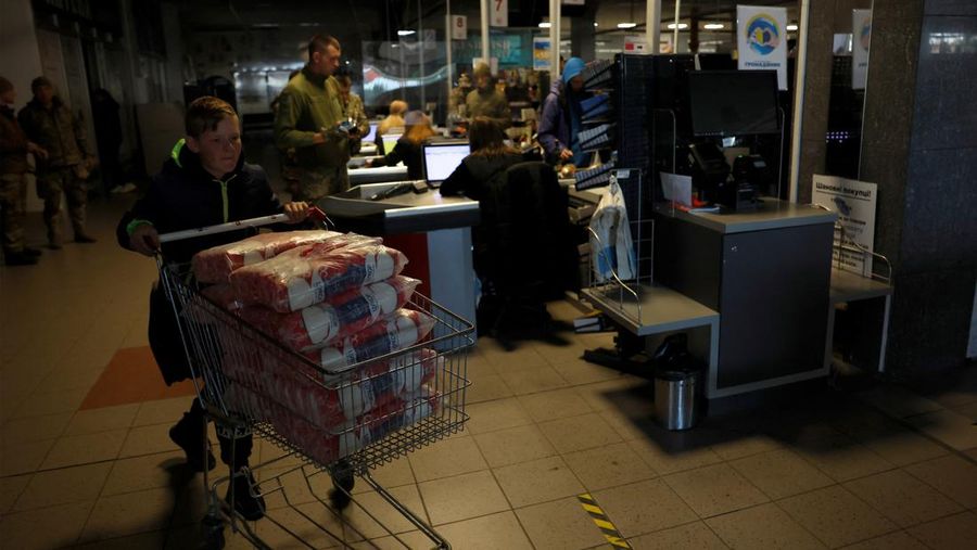 People shop in a supermarket as Kharkiv suffers an electricity outage, amid Russia's attack on Ukraine, in Kharkiv, Ukraine, October 17, 2022. REUTERS/Clodagh Kilcoyne