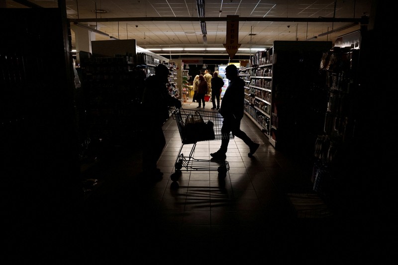 People shop in a supermarket as Kharkiv suffers an electricity outage, amid Russia's attack on Ukraine, in Kharkiv, Ukraine, October 17, 2022. REUTERS/Clodagh Kilcoyne