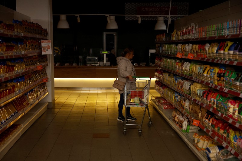 People shop in a supermarket as Kharkiv suffers an electricity outage, amid Russia's attack on Ukraine, in Kharkiv, Ukraine, October 17, 2022. REUTERS/Clodagh Kilcoyne