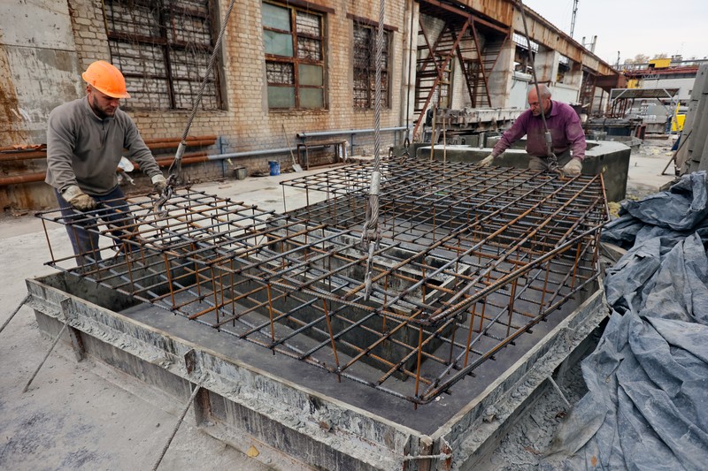 KHARKIV, UKRAINE - OCTOBER 19, 2022 - Men are seen during the production of the components for a concrete bomb shelter, Kharkiv, norheastern Ukraine. (Photo credit should read Vyacheslav Madiyevskyi / Ukrinform/Future Publishing via Getty Images)
