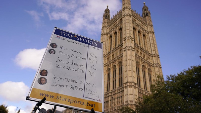 A bookmaker takes bets for the next British Prime Minister after Liz Truss resigned in London, Thursday, Oct. 20, 2022. Truss resigned Thursday, bowing to the inevitable after a tumultuous, short-lived term in which her policies triggered turmoil in financial markets and a rebellion in her party that obliterated her authority.(AP Photo/David Cliff)