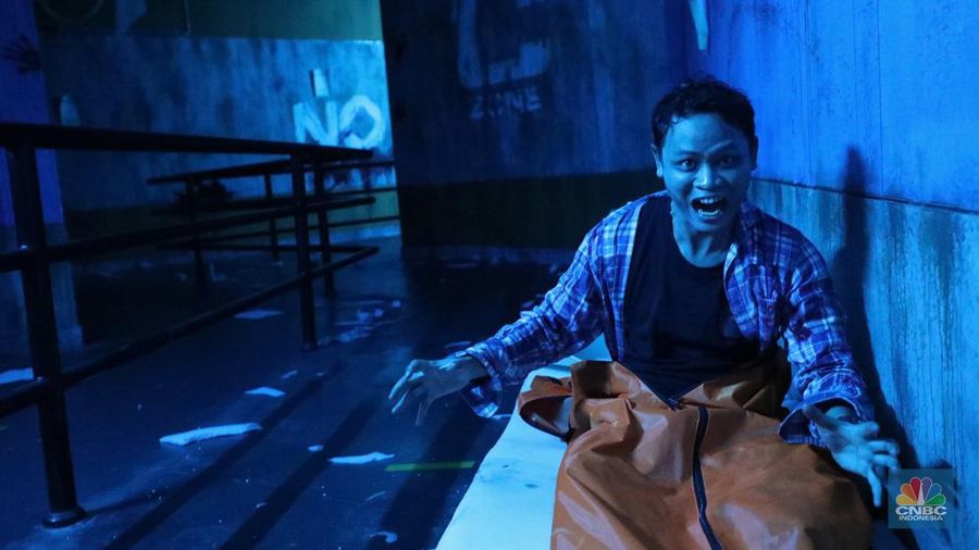 Pengunjung mencoba wahana Zombie Wars di Trans Studio Cibubur (TSM), Senin (24/10/22). Menyambut Halloween, TSM menghadirkan sesuatu yang mencekam sekaligus menantang di haunted house “Enigma Terror.  (CNBC Indonesia/ Tri Susilo)