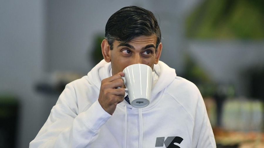 FILE - Britain's Chancellor Rishi Sunak sips a drink, as he attends a speed mentoring session for young people, during the launch of the government's Kickstart scheme aimed at helping young people into work as the labour market remains affected by the coronavirus pandemic, in Canary Wharf, London, Wednesday Sept. 2, 2020. Sunak ran for Britain’s top job and lost. Now he’s back with a second chance to become prime minister. (Daniel Leal-Olivas/Pool Photo via AP, File)