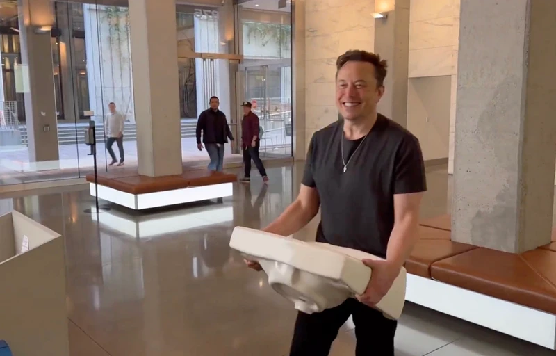 This image from the Twitter page of Elon Musk shows Musk entering Twitter headquarters carrying a sink through the lobby area on Wednesday, Oct. 26, 2022 in San Francisco.  Musk posted a video Wednesday showing him strolling into Twitter headquarters ahead of a Friday deadline to close his $44 billion deal to buy the company.  (Twitter page of Elon Musk via AP)