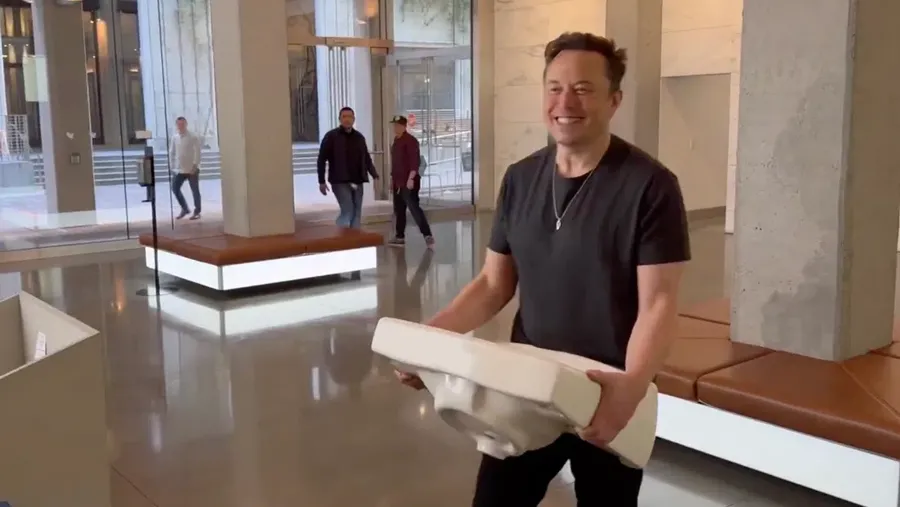 This image from the Twitter page of Elon Musk shows Musk entering Twitter headquarters carrying a sink through the lobby area on Wednesday, Oct. 26, 2022 in San Francisco.  Musk posted a video Wednesday showing him strolling into Twitter headquarters ahead of a Friday deadline to close his $44 billion deal to buy the company.  (Twitter page of Elon Musk via AP)
