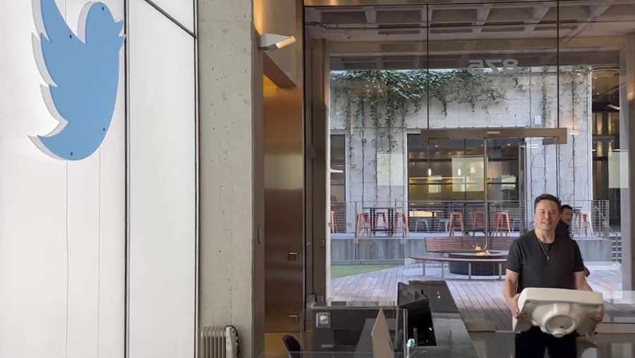 This image from the Twitter page of Elon Musk shows Musk entering Twitter headquarters carrying a sink through the lobby area on Wednesday, Oct. 26, 2022 in San Francisco.  Musk posted a video Wednesday showing him strolling into Twitter headquarters ahead of a Friday deadline to close his $44 billion deal to buy the company.  (Twitter page of Elon Musk via AP)