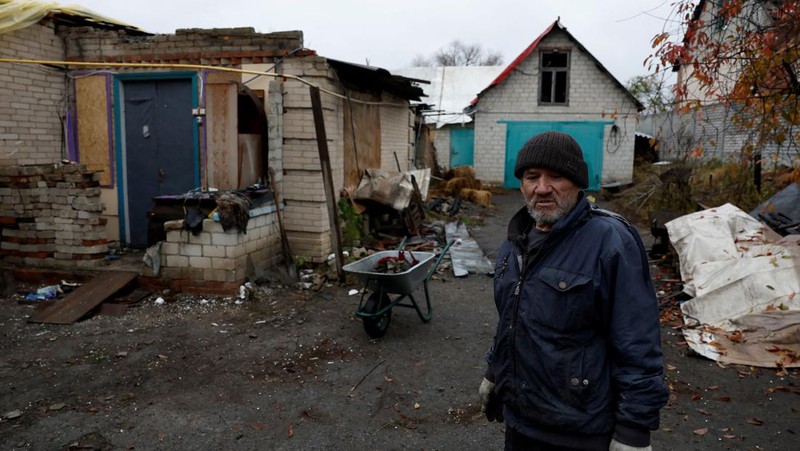 Myhaylo Yurkiv, 65, climbs out of the small bunker he stayed in for six months during fierce battles under Russian occupation which destroyed every home in the village and cut the village in two by the shelling of the bridge, leaving him now as the only person living on his side of the village, as Russia's invasion of Ukraine continues, in Tsupivka, Ukraine, October 26, 2022. REUTERS/Clodagh Kilcoyne     TPX IMAGES OF THE DAY