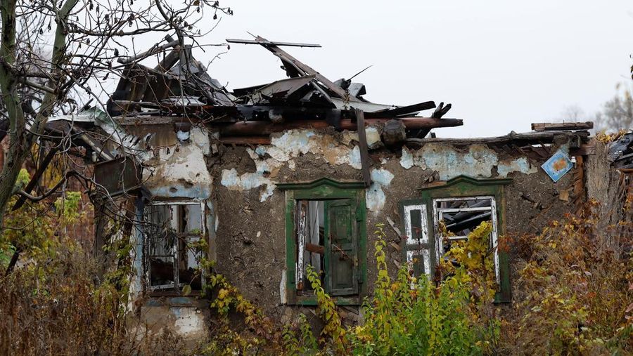 Myhaylo Yurkiv, 65, climbs out of the small bunker he stayed in for six months during fierce battles under Russian occupation which destroyed every home in the village and cut the village in two by the shelling of the bridge, leaving him now as the only person living on his side of the village, as Russia's invasion of Ukraine continues, in Tsupivka, Ukraine, October 26, 2022. REUTERS/Clodagh Kilcoyne     TPX IMAGES OF THE DAY