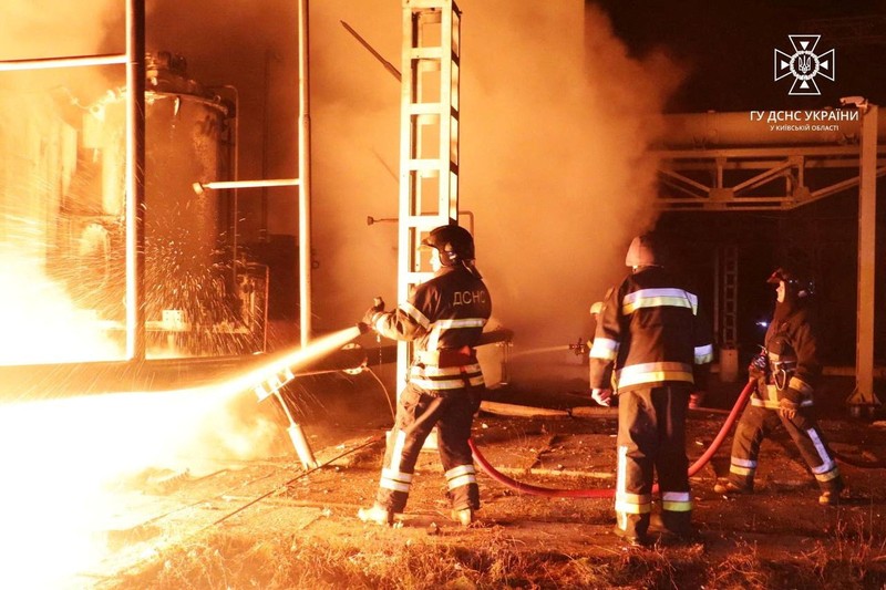 Firefighters work to put out a fire at energy infrastructure facilities, damaged by Russian drone strike, as Russia's attack on Ukraine continues, in undisclosed location, Ukraine October 27, 2022.  State Emergency Service of Ukraine/Handout via REUTERS    ATTENTION EDITORS -  THIS IMAGE HAS BEEN SUPPLIED BY A THIRD PARTY. MANDATORY CREDIT.