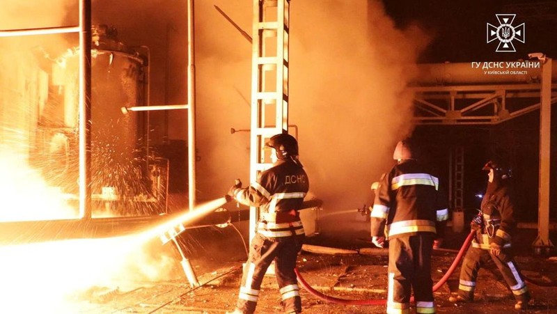 Firefighters work to put out a fire at energy infrastructure facilities, damaged by Russian drone strike, as Russia's attack on Ukraine continues, in undisclosed location, Ukraine October 27, 2022.  State Emergency Service of Ukraine/Handout via REUTERS    ATTENTION EDITORS -  THIS IMAGE HAS BEEN SUPPLIED BY A THIRD PARTY. MANDATORY CREDIT.