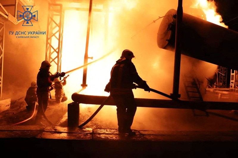 Firefighters work to put out a fire at energy infrastructure facilities, damaged by Russian drone strike, as Russia's attack on Ukraine continues, in undisclosed location, Ukraine October 27, 2022.  State Emergency Service of Ukraine/Handout via REUTERS    ATTENTION EDITORS -  THIS IMAGE HAS BEEN SUPPLIED BY A THIRD PARTY. MANDATORY CREDIT.