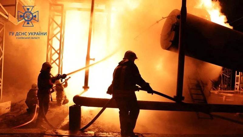 Firefighters work to put out a fire at energy infrastructure facilities, damaged by Russian drone strike, as Russia's attack on Ukraine continues, in undisclosed location, Ukraine October 27, 2022.  State Emergency Service of Ukraine/Handout via REUTERS    ATTENTION EDITORS -  THIS IMAGE HAS BEEN SUPPLIED BY A THIRD PARTY. MANDATORY CREDIT.