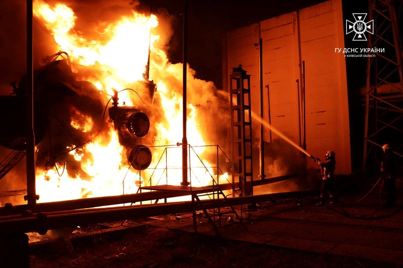 UKRAINE-CRISIS/KYIV Firefighters work to put out a fire at energy infrastructure facilities, damaged by Russian drone strike, as Russia's attack on Ukraine continues, in undisclosed location, Ukraine October 27, 2022. State Emergency Service of Ukraine/Handout via REUTERS ATTENTION EDITORS - THIS IMAGE HAS BEEN SUPPLIED BY A THIRD PARTY. MANDATORY CREDIT.