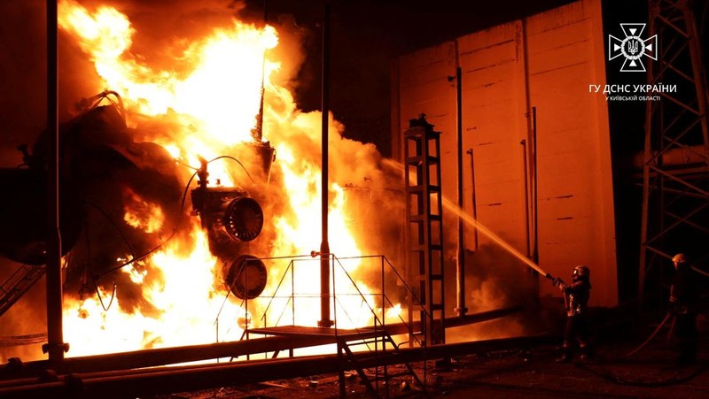 Firefighters work to put out a fire at energy infrastructure facilities, damaged by Russian drone strike, as Russia's attack on Ukraine continues, in undisclosed location, Ukraine October 27, 2022.  State Emergency Service of Ukraine/Handout via REUTERS    ATTENTION EDITORS -  THIS IMAGE HAS BEEN SUPPLIED BY A THIRD PARTY. MANDATORY CREDIT.