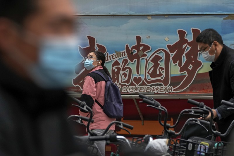 Residents wearing face masks wait in line to get their routine COVID-19 throat swabs at a coronavirus testing site in Beijing, Thursday, Oct. 27, 2022. China's ruling Communist Party has so far shown no sign of easing the 