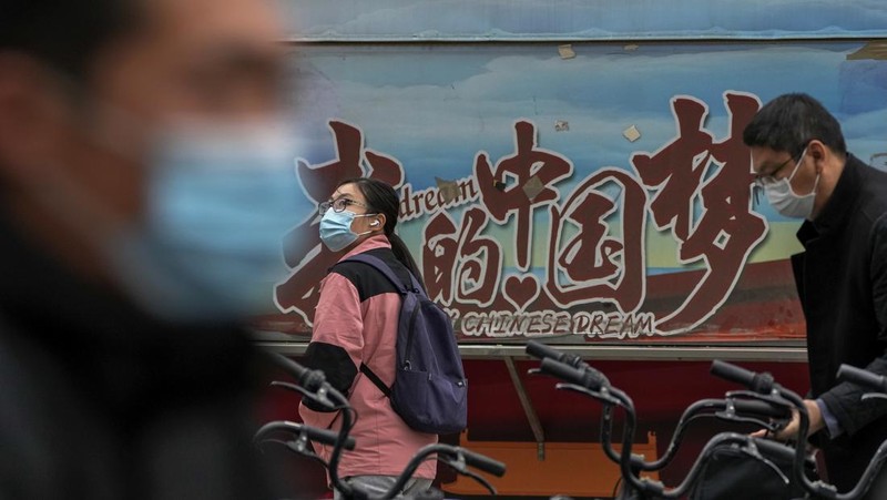Residents wearing face masks wait in line to get their routine COVID-19 throat swabs at a coronavirus testing site in Beijing, Thursday, Oct. 27, 2022. China's ruling Communist Party has so far shown no sign of easing the 