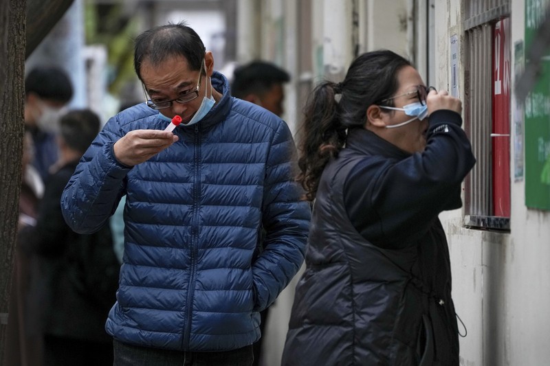 Virus Outbreak China Residents wearing face masks wait in line to get their routine COVID-19 throat swabs at a coronavirus testing site in Beijing, Thursday, Oct. 27, 2022. China's ruling Communist Party has so far shown no sign of easing the