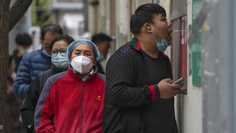 Residents wearing face masks wait in line to get their routine COVID-19 throat swabs at a coronavirus testing site in Beijing, Thursday, Oct. 27, 2022. China's ruling Communist Party has so far shown no sign of easing the 