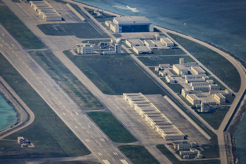 1436864964 SPRATLY ISLANDS, AT SEA - OCTOBER 25: An airfield, buildings, and structures are seen on the artificial island built by China in Subi Reef on October 25, 2022 in Spratly Islands, South China Sea. China has progressively asserted its claim of ownership over disputed islands in the South China Sea by artificially increasing the size of islands, creating new islands and building ports, military outposts and airstrips. The South China sea is an important trade route and is of significant interest as geopolitical tensions remain high in the region. (Photo by Ezra Acayan/Getty Images)