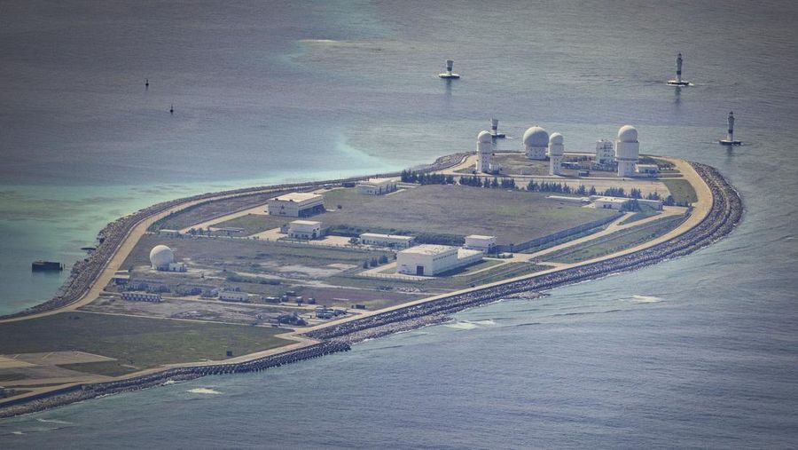 SPRATLY ISLANDS, AT SEA - OCTOBER 25: Buildings and structures are seen on the artificial island built by China in Mischief Reef on October 25, 2022 in Spratly Islands, South China Sea. China has progressively asserted its claim of ownership over disputed islands in the South China Sea by artificially increasing the size of islands, creating new islands and building ports, military outposts and airstrips. The South China sea is an important trade route and is of significant interest as geopolitical tensions remain high in the region. (Photo by Ezra Acayan/Getty Images)