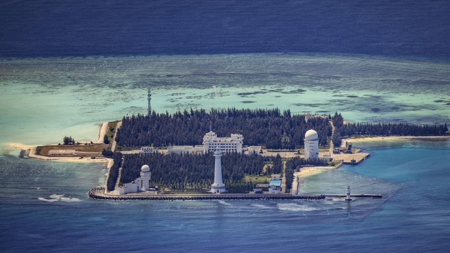 SPRATLY ISLANDS, AT SEA - OCTOBER 25: An airfield, buildings, and structures are seen on the artificial island built by China in Subi Reef on October 25, 2022 in Spratly Islands, South China Sea. China has progressively asserted its claim of ownership over disputed islands in the South China Sea by artificially increasing the size of islands, creating new islands and building ports, military outposts and airstrips. The South China sea is an important trade route and is of significant interest as geopolitical tensions remain high in the region. (Photo by Ezra Acayan/Getty Images)