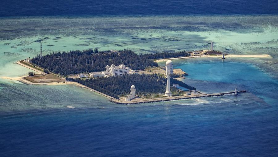 SPRATLY ISLANDS, AT SEA - OCTOBER 25: Buildings and structures are seen on the artificial island built by China in Gaven Reefs on October 25, 2022 in Spratly Islands, South China Sea. China has progressively asserted its claim of ownership over disputed islands in the South China Sea by artificially increasing the size of islands, creating new islands and building ports, military outposts and airstrips. The South China sea is an important trade route and is of significant interest as geopolitical tensions remain high in the region. (Photo by Ezra Acayan/Getty Images)