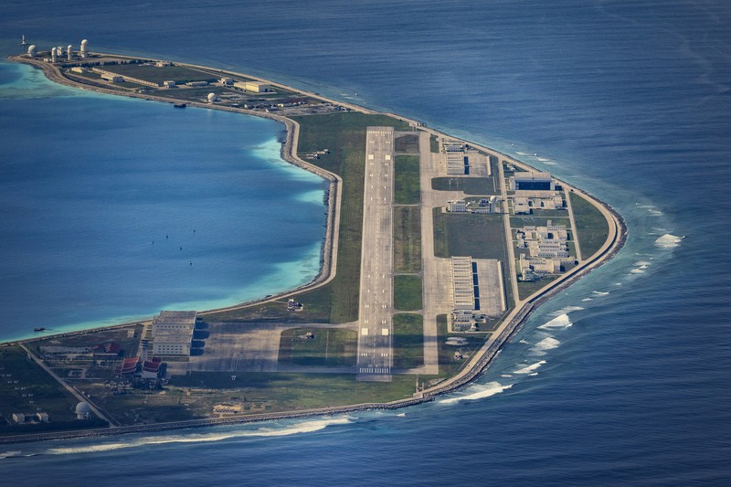 SPRATLY ISLANDS, AT SEA - OCTOBER 25: An airfield, buildings, and structures are seen on the artificial island built by China in Subi Reef on October 25, 2022 in Spratly Islands, South China Sea. China has progressively asserted its claim of ownership over disputed islands in the South China Sea by artificially increasing the size of islands, creating new islands and building ports, military outposts and airstrips. The South China sea is an important trade route and is of significant interest as geopolitical tensions remain high in the region. (Photo by Ezra Acayan/Getty Images)