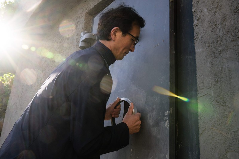TOPSHOT - This picture taken on October 17, 2022 shows architecture professor Lee Tae-goo opening a hatch door as he prepares to climb out of his bunker, which is buried one metre (three feet) deep and can protect from the radiation fallout of a nuclear blast on his property in Jecheon, some 74 miles (120 km) southeast of the capital Seoul. - If North Korea unleashes a nuclear attack on the South, architecture professor Lee Tae-goo plans to retreat to his purpose-built bunker -- which was funded by a government grant -- and stay underground for at least two weeks to avoid radiation poisoning. - To go with 'SKOREA-NKOREA-NUCLEAR-BUNKER,FOCUS' by Cat Barton and Kang Jin-kyu (Photo by Anthony WALLACE / AFP) / To go with 'SKOREA-NKOREA-NUCLEAR-BUNKER,FOCUS' by Cat Barton and Kang Jin-kyu (Photo by ANTHONY WALLACE/AFP via Getty Images)