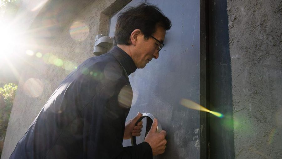 TOPSHOT - This picture taken on October 17, 2022 shows architecture professor Lee Tae-goo opening a hatch door as he prepares to climb out of his bunker, which is buried one metre (three feet) deep and can protect from the radiation fallout of a nuclear blast on his property in Jecheon, some 74 miles (120 km) southeast of the capital Seoul. - If North Korea unleashes a nuclear attack on the South, architecture professor Lee Tae-goo plans to retreat to his purpose-built bunker -- which was funded by a government grant -- and stay underground for at least two weeks to avoid radiation poisoning. - To go with 'SKOREA-NKOREA-NUCLEAR-BUNKER,FOCUS' by Cat Barton and Kang Jin-kyu (Photo by Anthony WALLACE / AFP) / To go with 'SKOREA-NKOREA-NUCLEAR-BUNKER,FOCUS' by Cat Barton and Kang Jin-kyu (Photo by ANTHONY WALLACE/AFP via Getty Images)