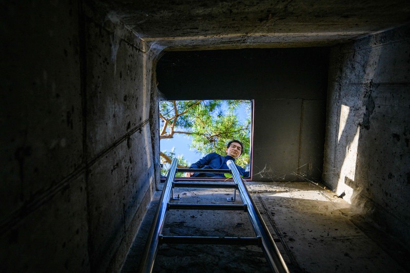 1244258723 TOPSHOT - This picture taken on October 17, 2022 shows architecture professor Lee Tae-goo opening a hatch door as he prepares to climb out of his bunker, which is buried one metre (three feet) deep and can protect from the radiation fallout of a nuclear blast on his property in Jecheon, some 74 miles (120 km) southeast of the capital Seoul. - If North Korea unleashes a nuclear attack on the South, architecture professor Lee Tae-goo plans to retreat to his purpose-built bunker -- which was funded by a government grant -- and stay underground for at least two weeks to avoid radiation poisoning. - To go with 'SKOREA-NKOREA-NUCLEAR-BUNKER,FOCUS' by Cat Barton and Kang Jin-kyu (Photo by Anthony WALLACE / AFP) / To go with 'SKOREA-NKOREA-NUCLEAR-BUNKER,FOCUS' by Cat Barton and Kang Jin-kyu (Photo by ANTHONY WALLACE/AFP via Getty Images)