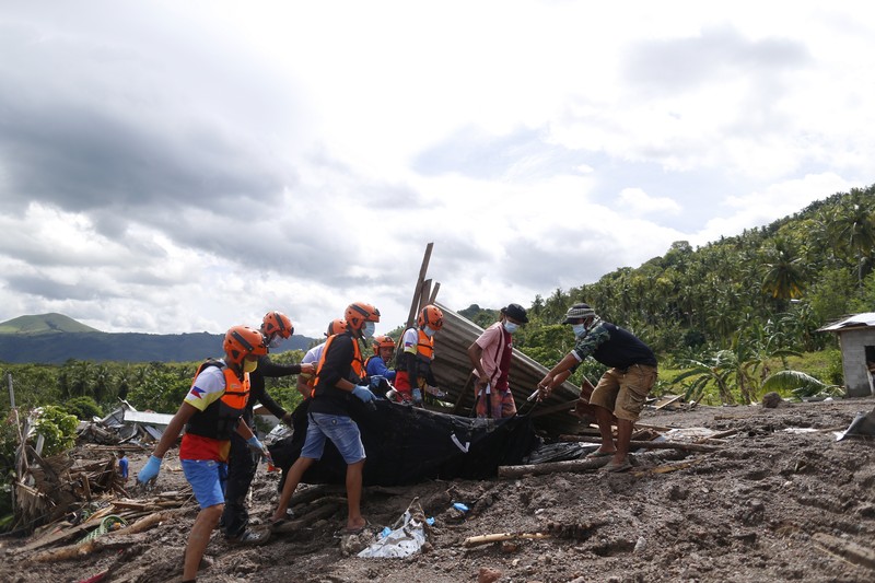 Petugas penyelamat Philippine Coast Guard (PCG) dan Philippine National Police (PNP) mengevakuasi jenazah korban banjir dan tanah longsor akibat Badai Tropis Nalgae, di Datu Odin Sinsuat, Maguindanao, 28 Oktober 2022. (Philippine Coast Guard/Handout via REUTERS)