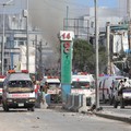 Security personnel and ambulances are stationed near destroyed and damaged buildings after an car bombing targeted the education ministry in Mogadishu on October 29, 2022. - Two huge car bombings rocked Somalia's education ministry in the capital Mog