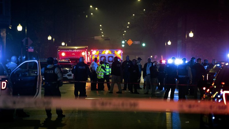 Chicago police and emergency medical responders work at the scene of a mass shooting near Polk Street and California Avenue on the city's West Side on Monday, Oct. 31, 2022.  Chicago Police say several people were injured in a drive-by shooting Halloween night, including three children (E. Jason Wambsgans /Chicago Tribune via AP)