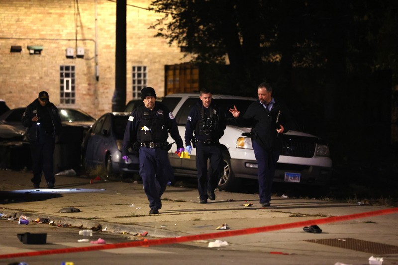 Halloween-Shootings Chicago Chicago police and emergency medical responders work at the scene of a mass shooting near Polk Street and California Avenue on the city's West Side on Monday, Oct. 31, 2022. Chicago Police say several people were injured in a drive-by shooting Halloween night, including three children (E. Jason Wambsgans /Chicago Tribune via AP)