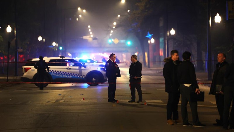 Chicago police and emergency medical responders work at the scene of a mass shooting near Polk Street and California Avenue on the city's West Side on Monday, Oct. 31, 2022.  Chicago Police say several people were injured in a drive-by shooting Halloween night, including three children (E. Jason Wambsgans /Chicago Tribune via AP)