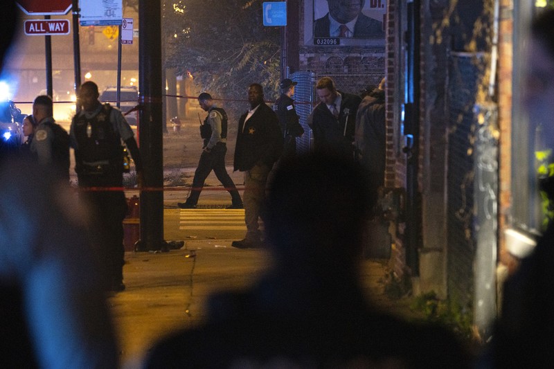 Halloween-Shootings Chicago Chicago police and emergency medical responders work at the scene of a mass shooting near Polk Street and California Avenue on the city's West Side on Monday, Oct. 31, 2022. Chicago Police say several people were injured in a drive-by shooting Halloween night, including three children (E. Jason Wambsgans /Chicago Tribune via AP)