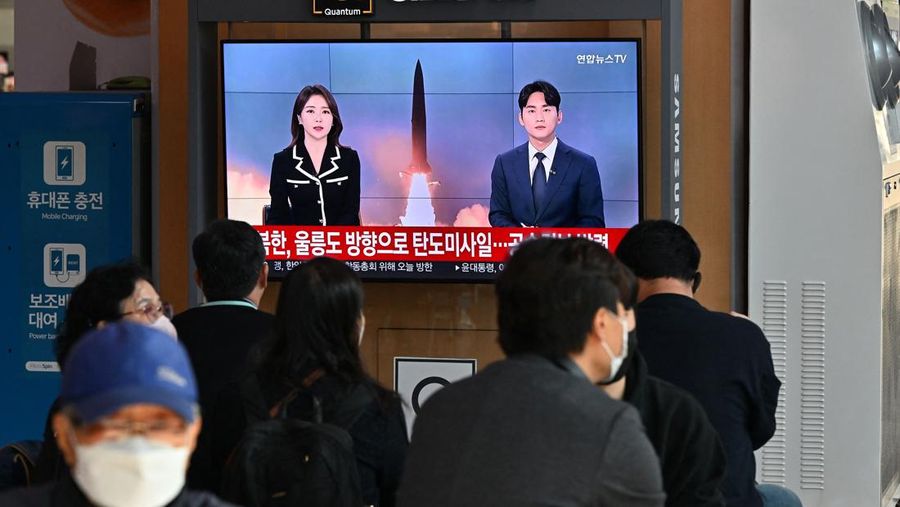 People watch a television screen showing a news broadcast with file footage of a North Korean missile test, at a railway station in Seoul on November 2, 2022. - South Korea on November 2 told residents on the island of Ulleungdo off its east coast to evacuate to bunkers after North Korea fired three short range ballistic missiles. (JUNG YEON-JE/AFP via Getty Images)