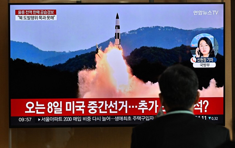 People watch a television screen showing a news broadcast with file footage of a North Korean missile test, at a railway station in Seoul on November 2, 2022. - South Korea on November 2 told residents on the island of Ulleungdo off its east coast to evacuate to bunkers after North Korea fired three short range ballistic missiles. (JUNG YEON-JE/AFP via Getty Images)