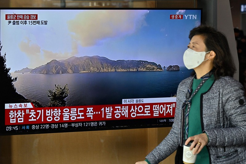 People watch a television screen showing a news broadcast with file footage of a North Korean missile test, at a railway station in Seoul on November 2, 2022. - South Korea on November 2 told residents on the island of Ulleungdo off its east coast to evacuate to bunkers after North Korea fired three short range ballistic missiles. (JUNG YEON-JE/AFP via Getty Images)