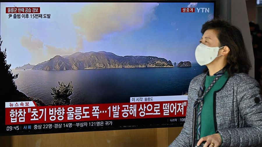 People watch a television screen showing a news broadcast with file footage of a North Korean missile test, at a railway station in Seoul on November 2, 2022. - South Korea on November 2 told residents on the island of Ulleungdo off its east coast to evacuate to bunkers after North Korea fired three short range ballistic missiles. (JUNG YEON-JE/AFP via Getty Images)