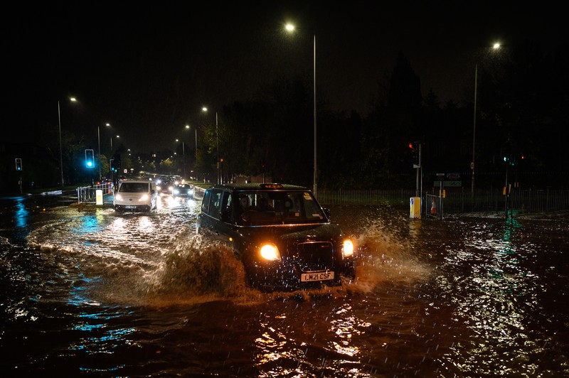 London, England. Torrential rain and flash flooding LONDON, ENGLAND - NOVEMBER 02: Vehicles negotiate a flooded section of the A1 road on November 02, 2022 in London, England. Torrential rain and flash flooding hit the region late on Wednesday evening, causing traffic jams as cars became stuck in the standing water. (Leon Neal/Getty Images)