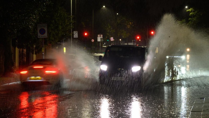 LONDON, ENGLAND - NOVEMBER 02: A car negotiates a flooded section of the A1 road on November 02, 2022 in London, England. Torrential rain and flash flooding hit the region late on Wednesday evening, causing traffic jams as cars became stuck in the standing water. (Photo by Leon Neal/Getty Images)