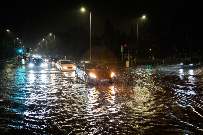 LONDON, ENGLAND - NOVEMBER 02: Vehicles negotiate a flooded section of the A1 road on November 02, 2022 in London, England. Torrential rain and flash flooding hit the region late on Wednesday evening, causing traffic jams as cars became stuck in the standing water. (Leon Neal/Getty Images)