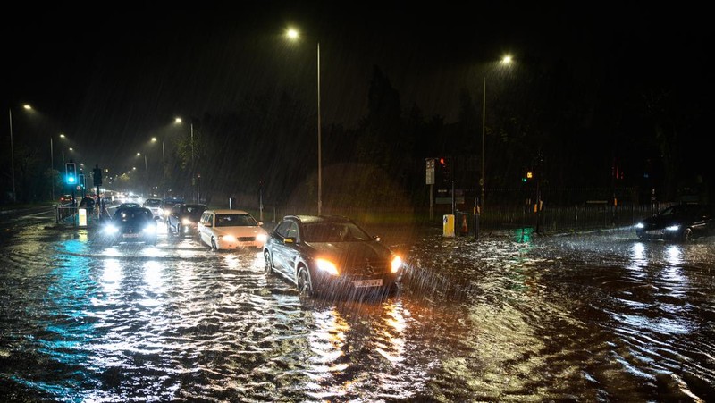 LONDON, ENGLAND - NOVEMBER 02: A car negotiates a flooded section of the A1 road on November 02, 2022 in London, England. Torrential rain and flash flooding hit the region late on Wednesday evening, causing traffic jams as cars became stuck in the standing water. (Photo by Leon Neal/Getty Images)