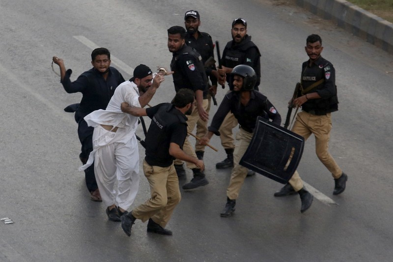 Seorang petugas polisi menembakkan gas air mata untuk membubarkan orang-orang selama protes mengutuk insiden penembakan pada long march yang diadakan oleh mantan Perdana Menteri Pakistan Imran Khan di Wazirabad, di Rawalpindi, Pakistan 4 November 2022. (REUTERS/STRINGER) Seorang petugas polisi menembakkan gas air mata untuk membubarkan orang-orang selama protes mengutuk insiden penembakan pada long march yang diadakan oleh mantan Perdana Menteri Pakistan Imran Khan di Wazirabad, di Rawalpindi, Pakistan 4 November 2022. (REUTERS/STRINGER)