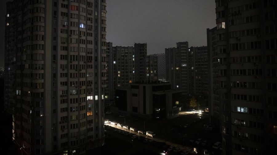 KYIV, UKRAINE - NOVEMBER 06: Cars drive between apartment blocks in near total darkness during a scheduled power cut on the left bank of the River Dnipro November 06, 2022 in Kyiv, Ukraine. Electricity and heating outages across Ukraine caused by missile and drone strikes to energy infrastructure have added urgency preparations for winter. (Photo by Ed Ram/Getty Images)
