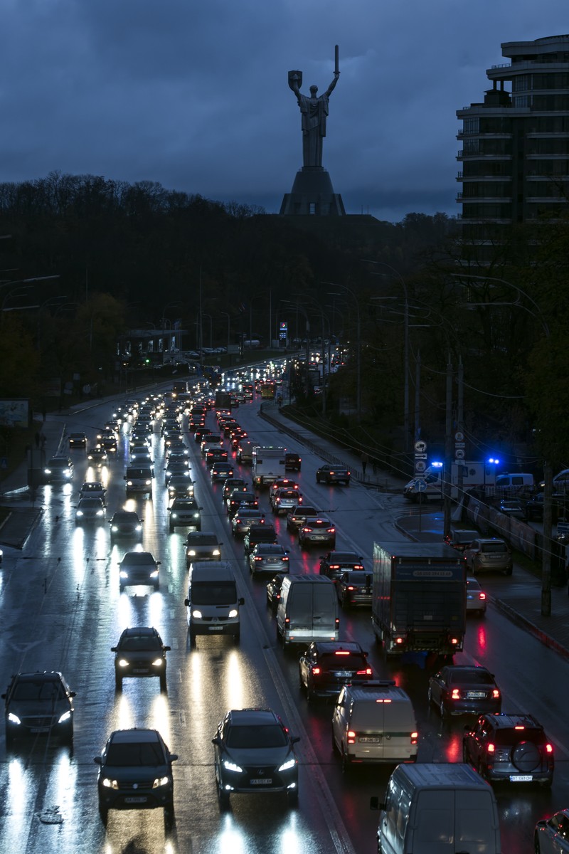 KYIV, UKRAINE - NOVEMBER 06: Cars drive between apartment blocks in near total darkness during a scheduled power cut on the left bank of the River Dnipro November 06, 2022 in Kyiv, Ukraine. Electricity and heating outages across Ukraine caused by missile and drone strikes to energy infrastructure have added urgency preparations for winter. (Photo by Ed Ram/Getty Images)